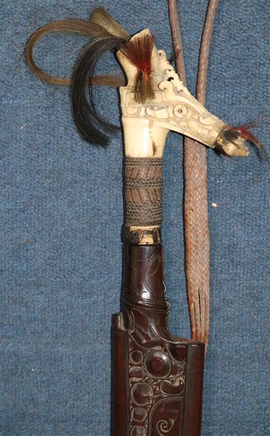A Dayak stag horn-handled Mandau (head-hunters sword), wood scabbard, late 19th / early 20th century, total length 78.5cm (30.9in.)
